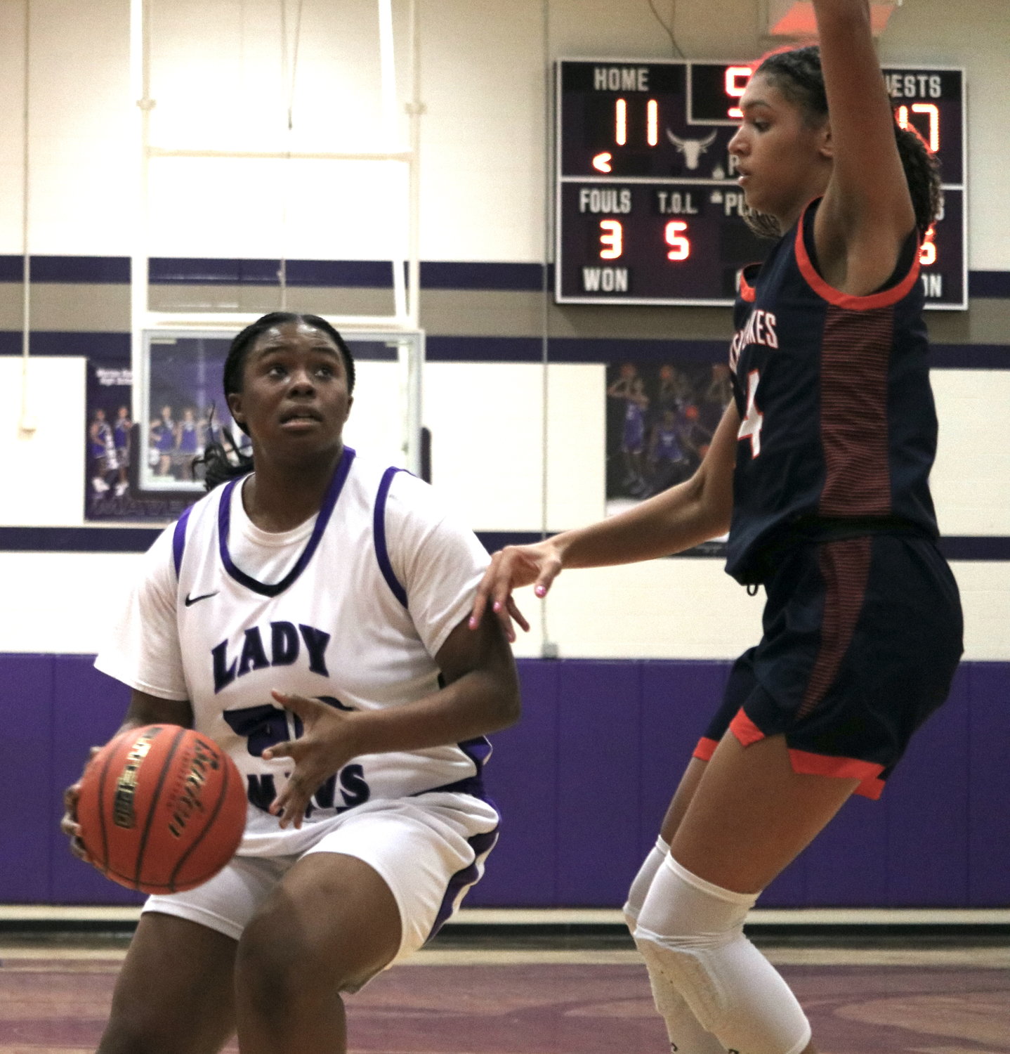Divine Favor Ekuma tries to shoot while guarded by Madison Carlton during Friday's game between Seven Lakes and Morton Ranch at the Morton Ranch gym.