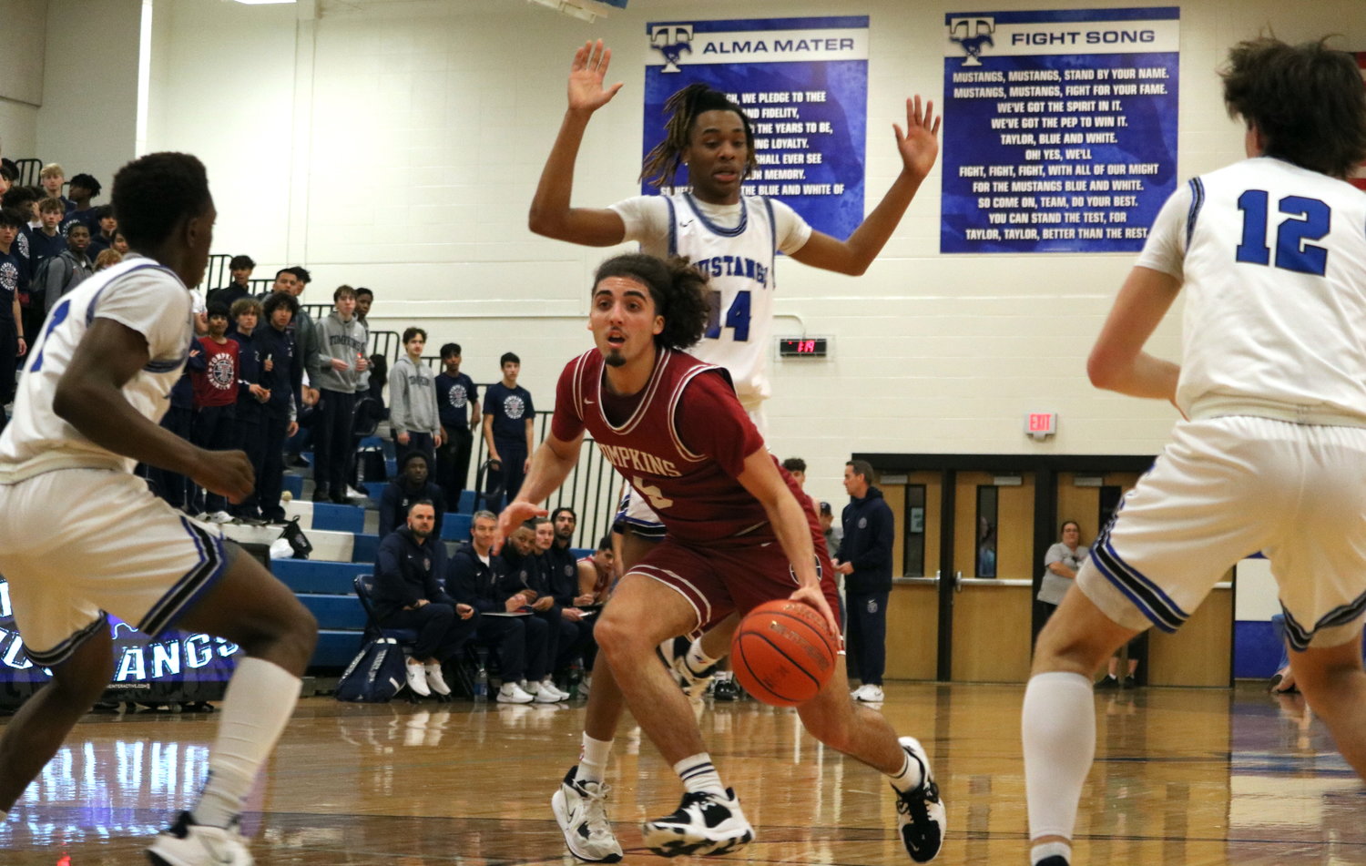 Luke Caughran dribbles through the Taylor defense during Saturday's game between Tompkins and Taylor at the Taylor gym.