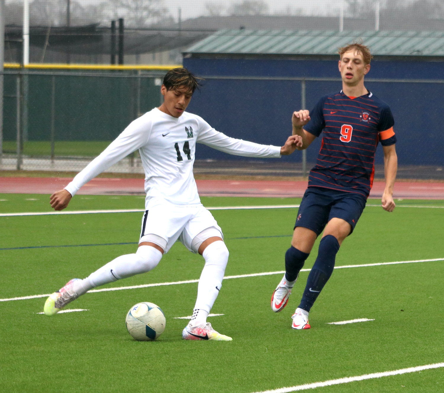 Danile Solorio clears a ball as Hunter Merritt closes in during Saturday's game between Seven Lakes and Mayde Creek at the Seven Lakes soccer field.