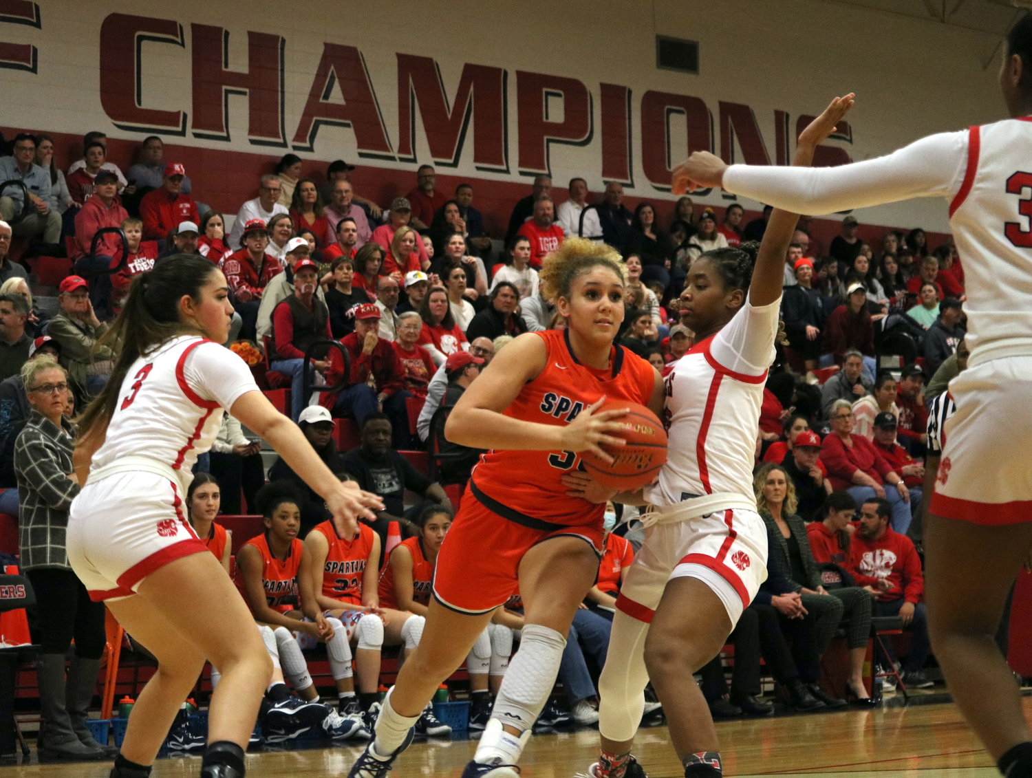 Seven Lakes drives past two defenders during Friday's game between Seven Lakes and Katy at the Katy gym.