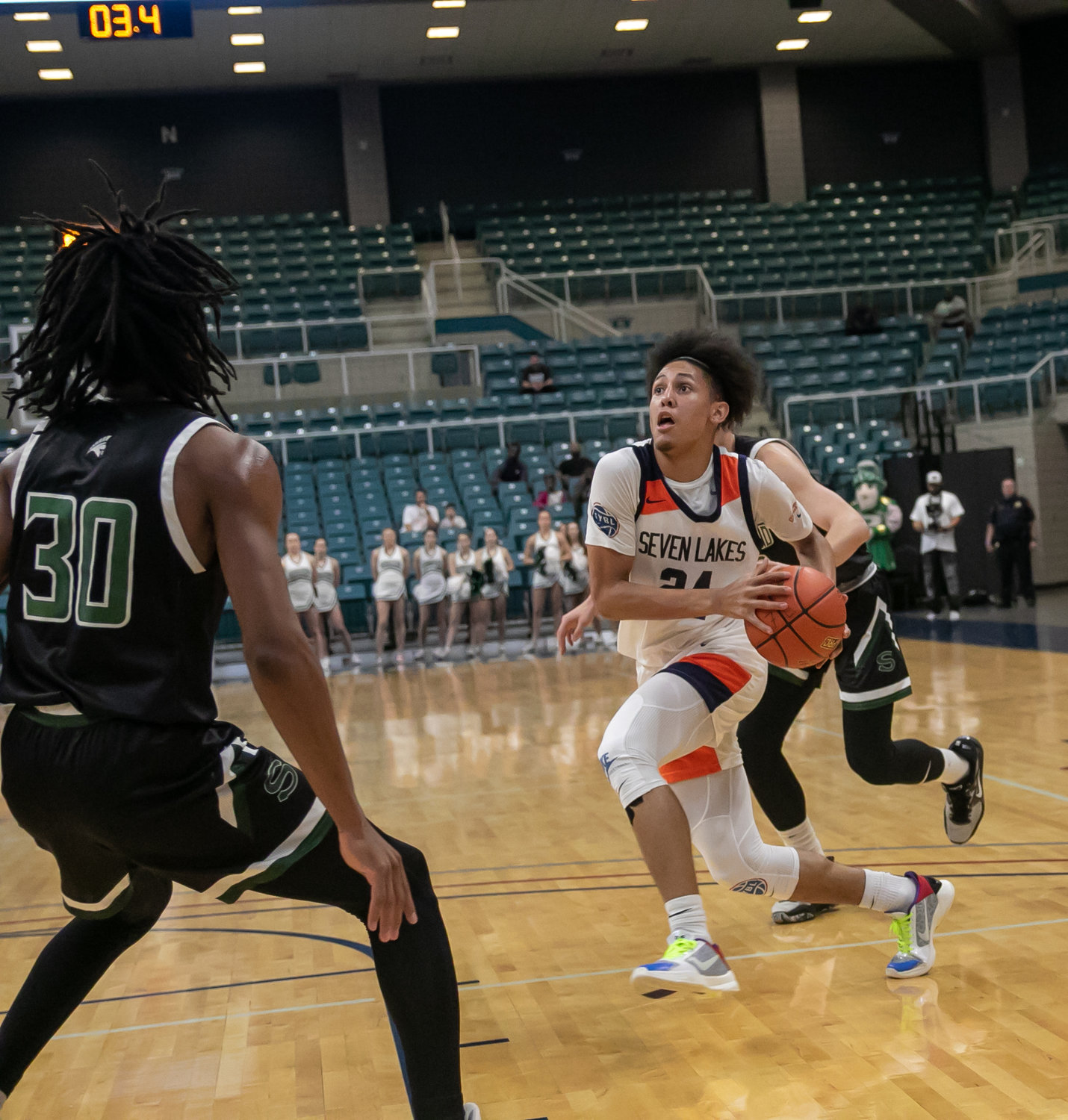 AJ Bates drives into the lane during a Class 6A Regional Quarterfinal between Seven Lakes and Stratford at the Merrell Center.