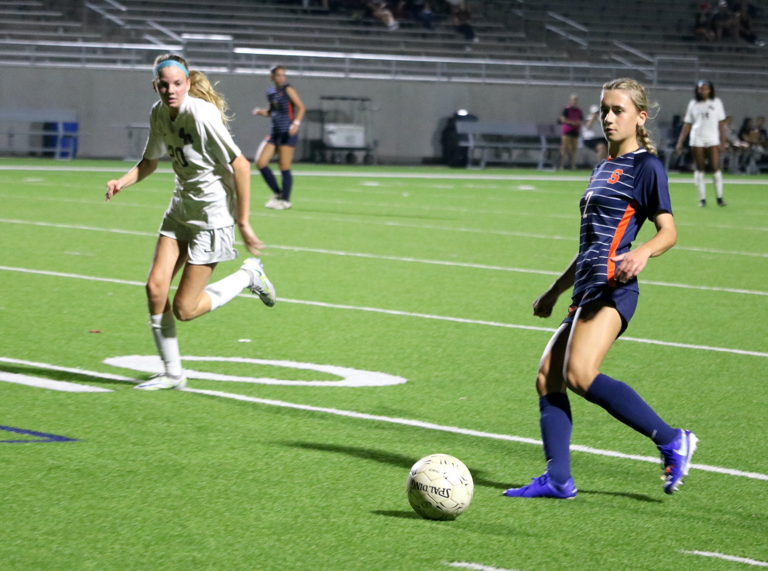 Vicky Ott passes a ball during Friday's bi-district game between Seven Lakes and George Ranch at Legacy Stadium.