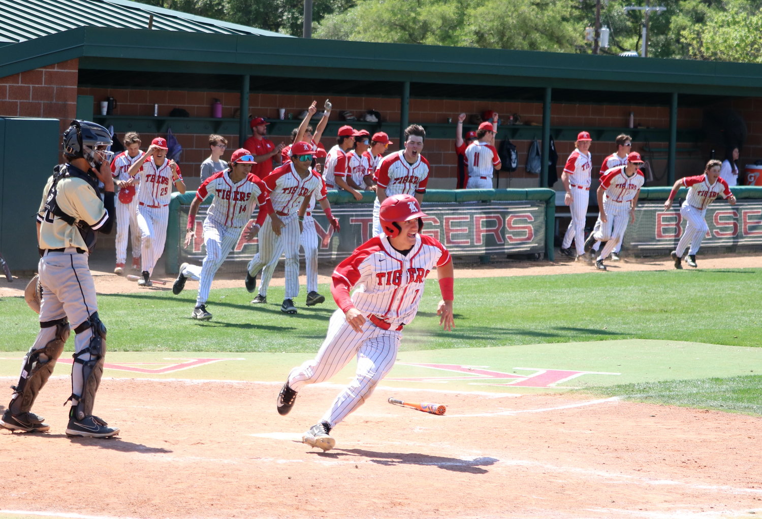 Brady Englett runs to celebrate after scoring the game winning run during Saturday's game between Katy and Jordan at the Katy baseball field.
