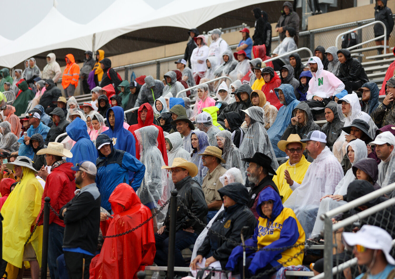 Fans watch the Class 1A boys pole vault event just before the wet conditions and lighting in the area forced UIL officials to pause the meet just 40 minutes after a delayed start on Saturday, May 13, 2023 in Austin.