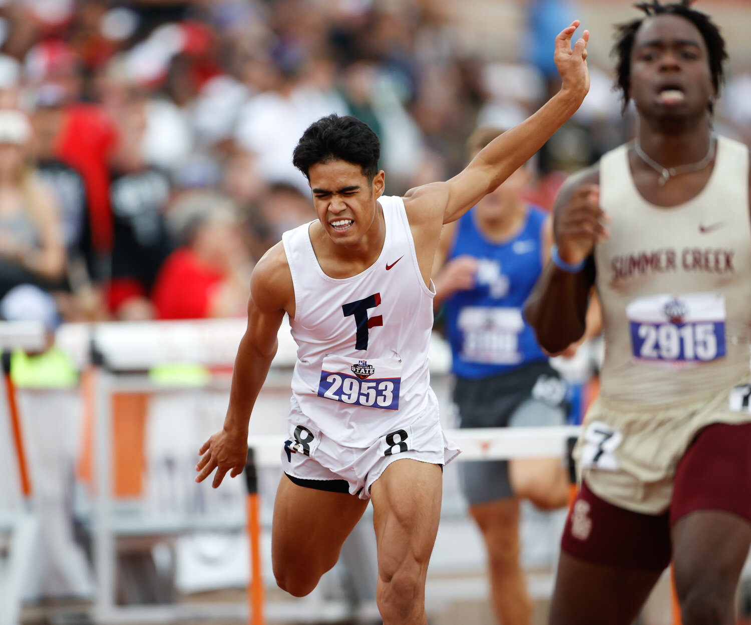 Jayden Keys of Tompkins High School (2953) crosses the finish line third, winning the bronze medal, in the Class 6A boys 300-meter hurdles during the UIL State Track and Field Meet on Saturday, May 13, 2023 in Austin.
