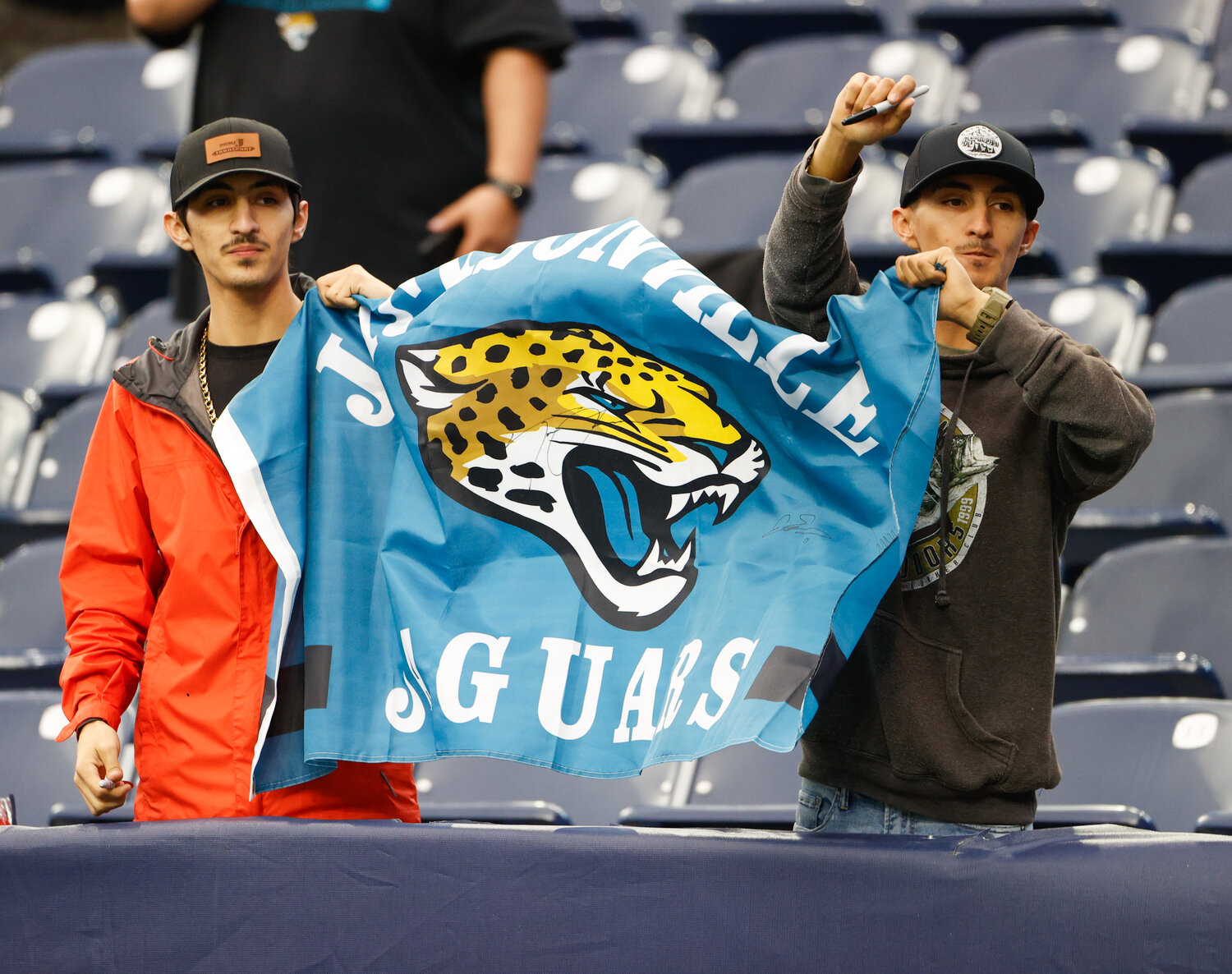 Jacksonville Jaguars fans hold up a banner before the start of an NFL game between the Texans and the Jaguars on November 26, 2023, in Houston.