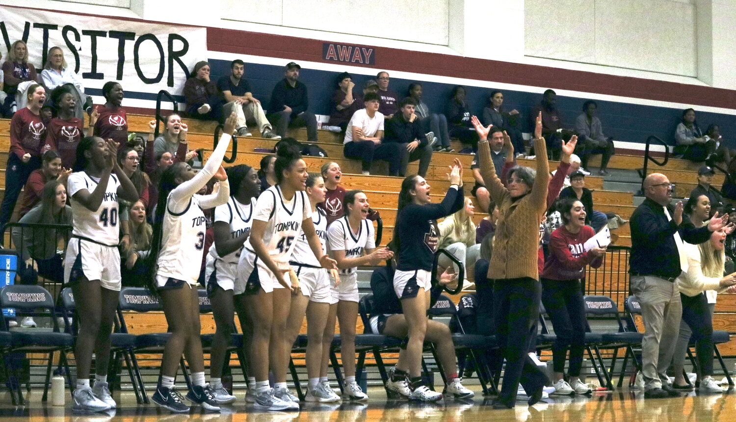 The Tompkins bench celebrates after a 3-pointer during Tuesday's game between Tompkins and Cinco Ranch at the Tompkins gym.