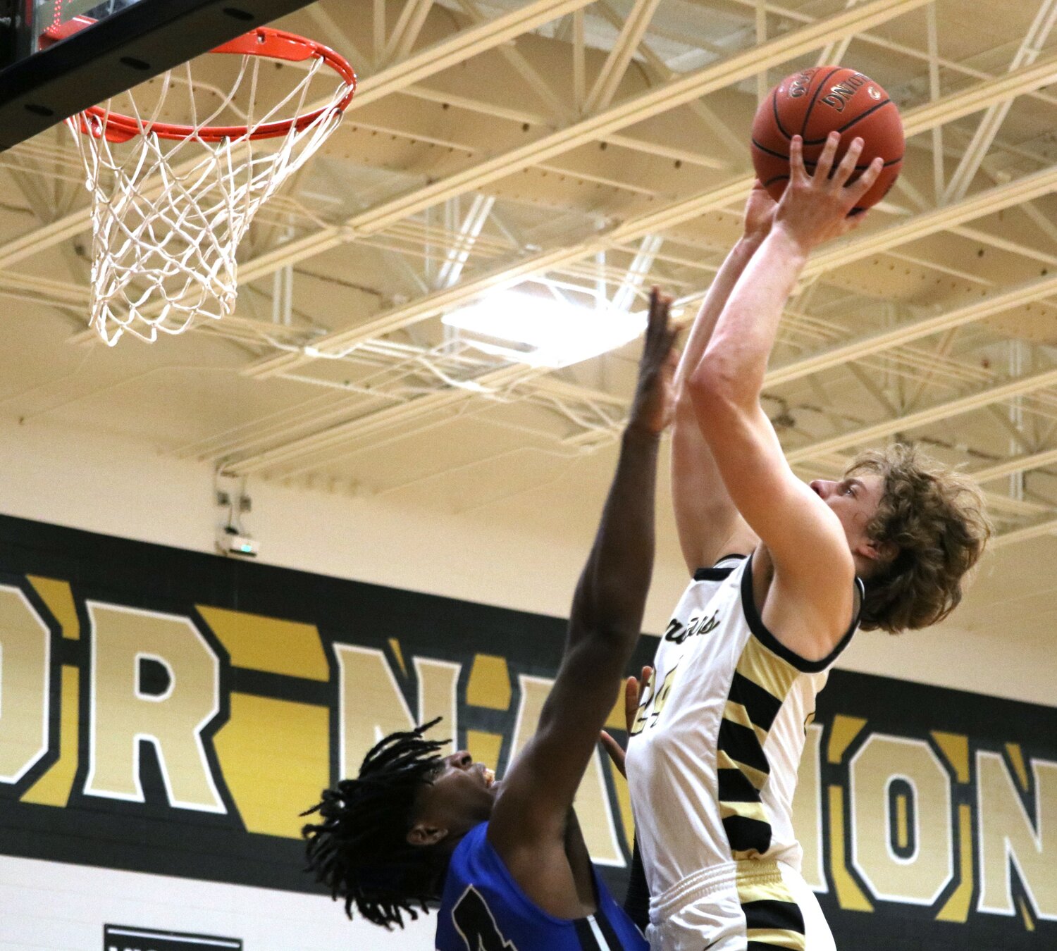 Landon Kjar goes up for a basket over a defender during Friday's game between Jordan and Westside at the Jordan gym.