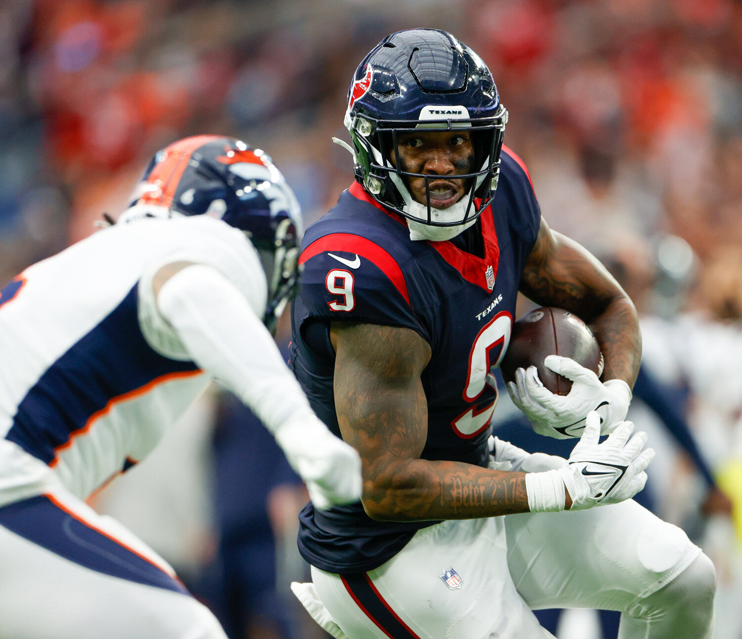 Texans tight end Brevin Jordan (9) carries the ball after a catch during an NFL game between the Texans and the Broncos on December 3, 2023 in Houston. The Texans won, 22-17.