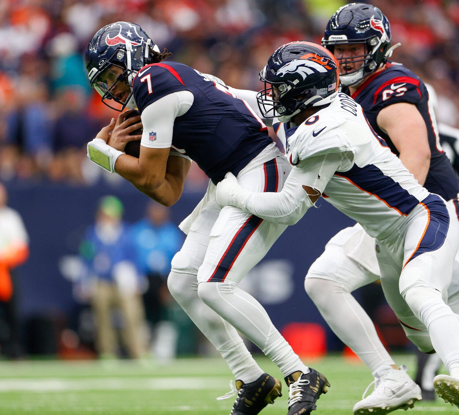 Texans quarterback C.J. Stroud (7) is tackled by Broncos linebacker Jonathon Cooper (0) during an NFL game between the Texans and the Broncos on December 3, 2023 in Houston. The Texans won, 22-17.