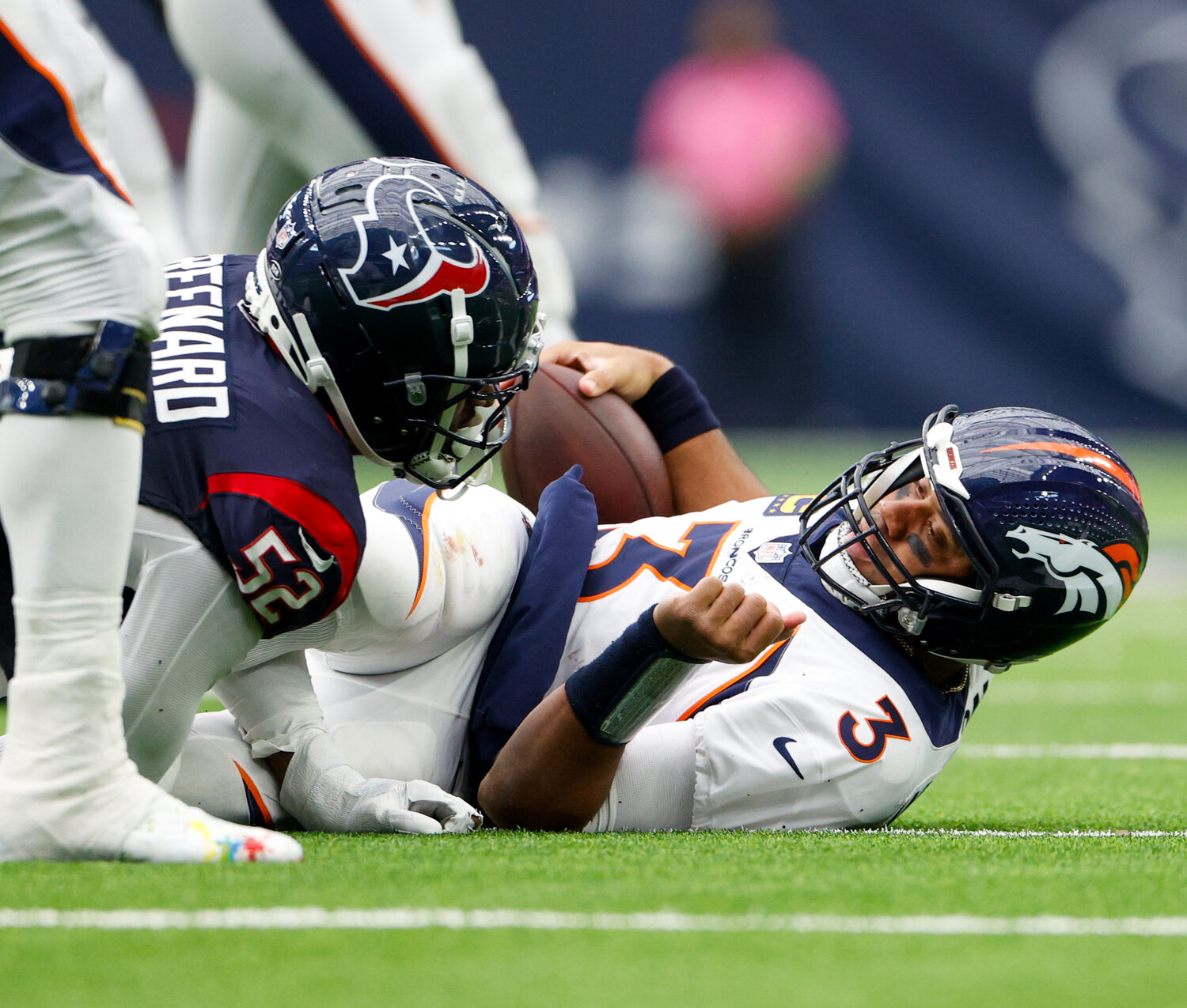 Broncos quarterback Russell Wilson (3) is sacked by Texans defensive end Jonathan Greenard (52) during an NFL game between the Texans and the Broncos on December 3, 2023 in Houston. The Texans won, 22-17.