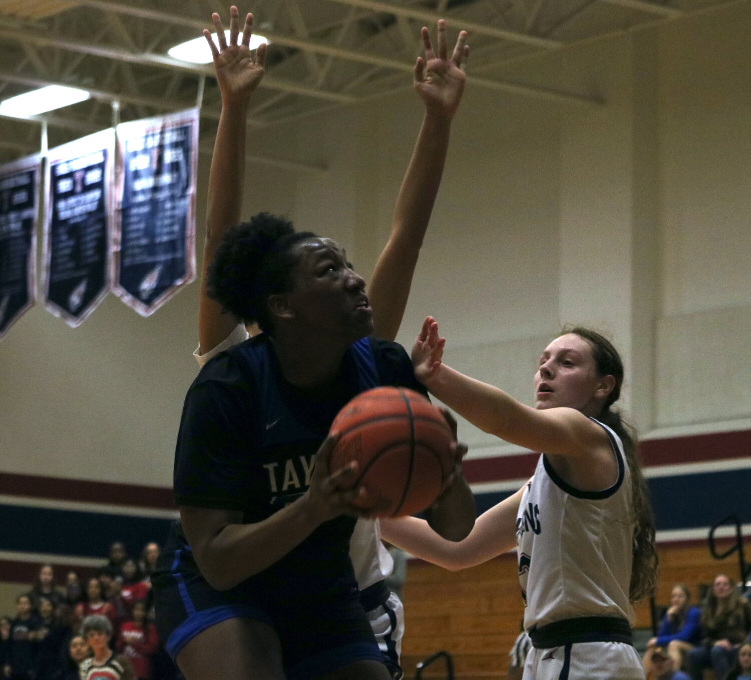 Timya Grice goes up for a shot during Friday's game between Taylor and Tompkins at the Tompkins gym.