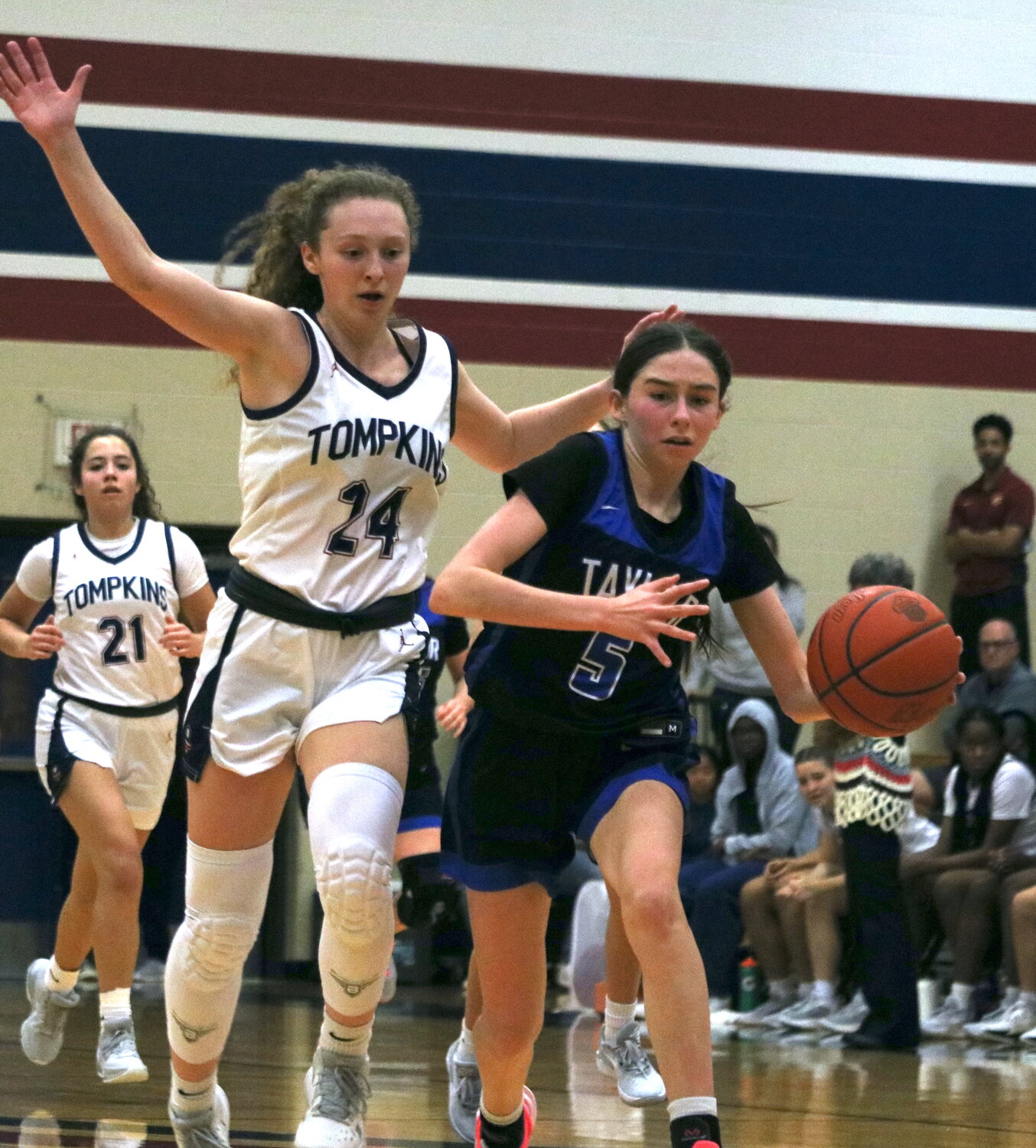 Casey Scherpereel dribbles up the court during Friday's game between Taylor and Tompkins at the Tompkins gym.