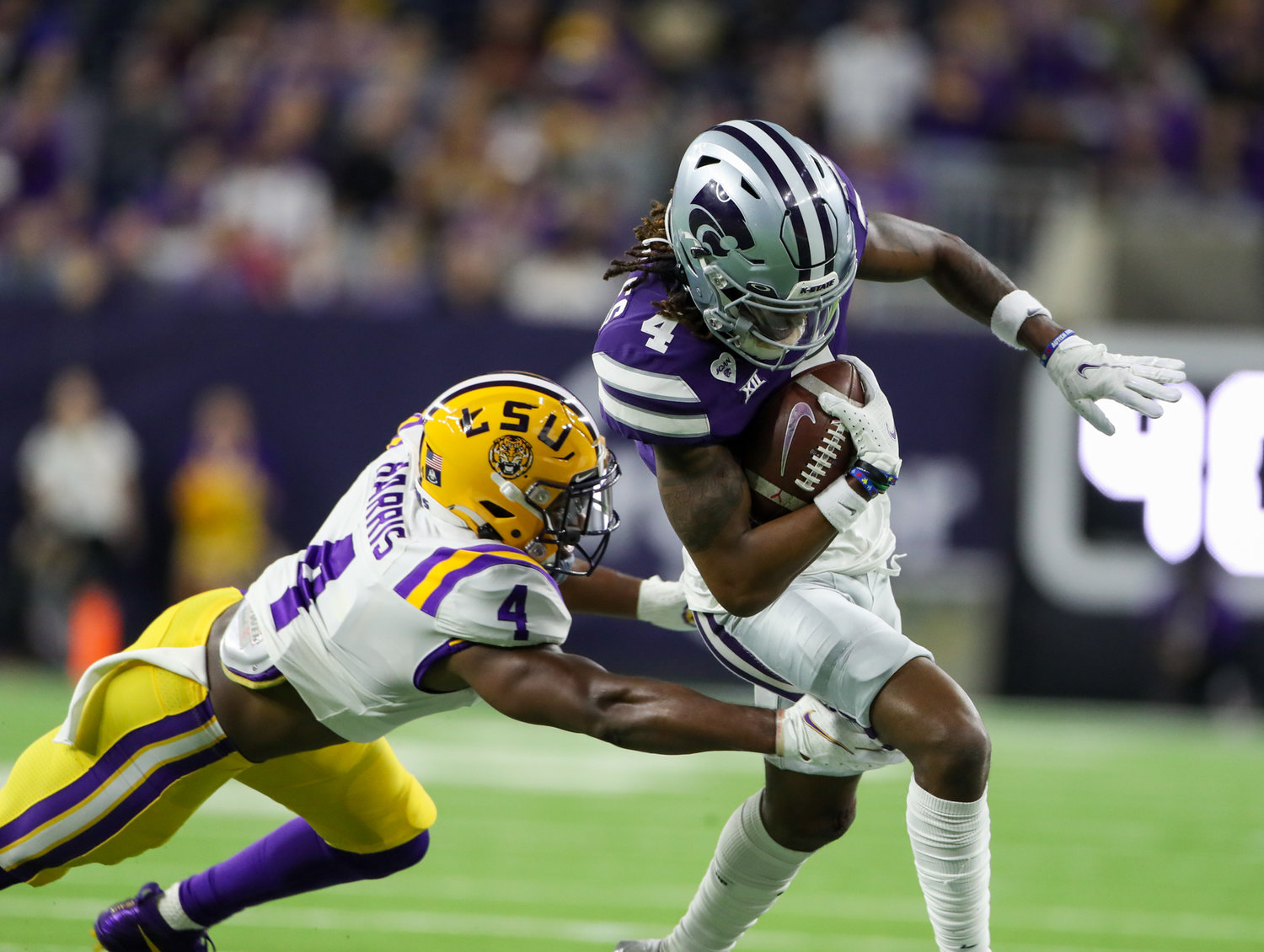 Kansas State Wildcats wide receiver Malik Knowles (4) carries the ball past LSU Tigers safety Todd Harris Jr. (4) during the TaxAct Texas Bowl on Jan. 4, 2022 in Houston, Texas.