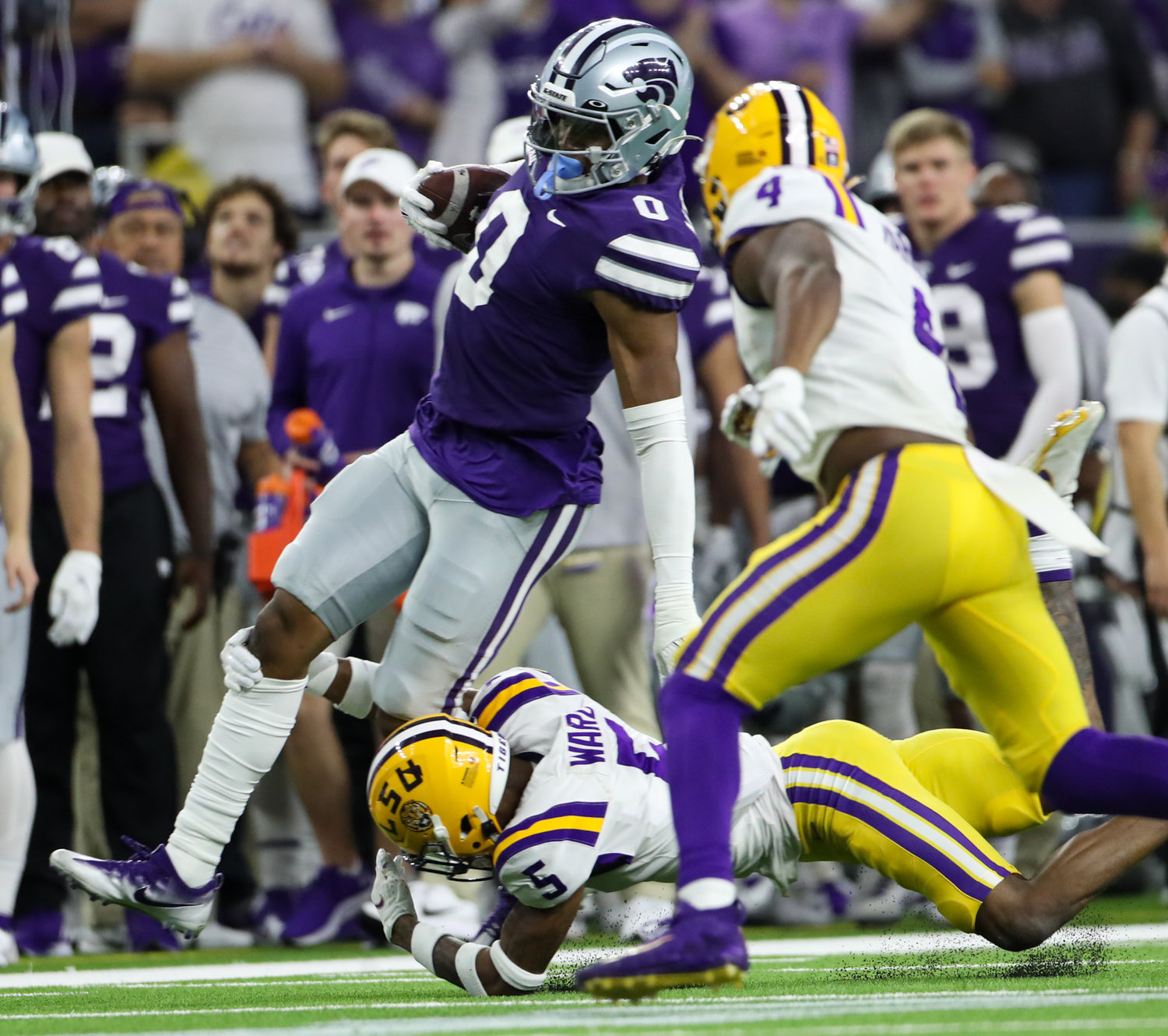LSU Tigers safety Jay Ward (5) tackles Kansas State Wildcats tight end Daniel Imatorbhebhe (0) during the TaxAct Texas Bowl on Jan. 4, 2022 in Houston, Texas.