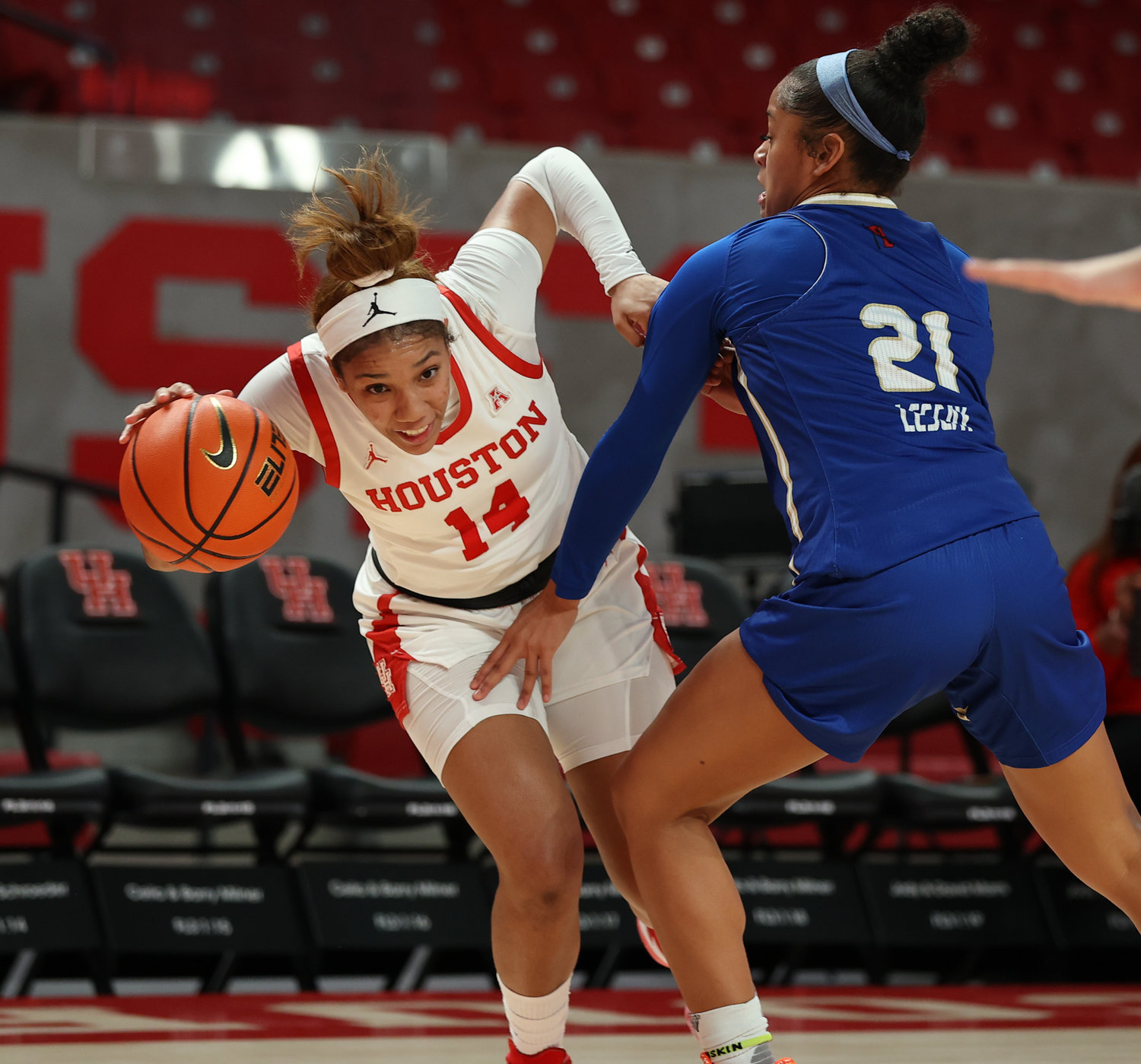 Houston Cougars guard Laila Blair (14) moves the ball against Tulsa Golden Hurricane guard Rebecca Lescay (21) during an NCAA women’s basketball game on Jan. 8, 2022 in Houston, Texas.