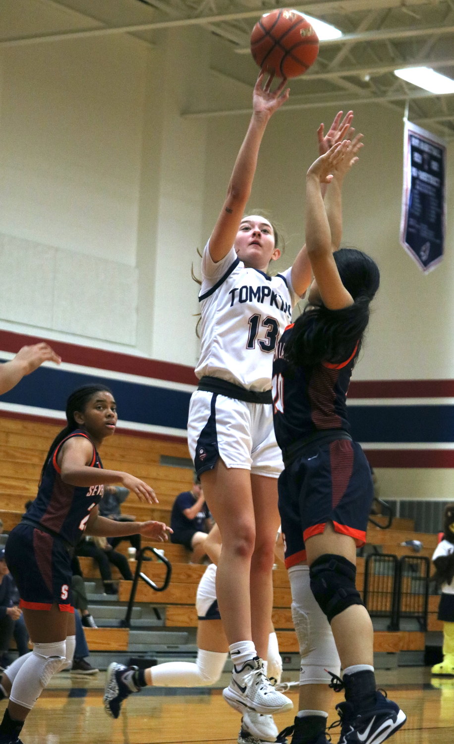 Macy Spencer shoots a fadeaway during Tuesday’s District 19-6A game between Tompkins and Seven Lakes at the Tompkins gym.