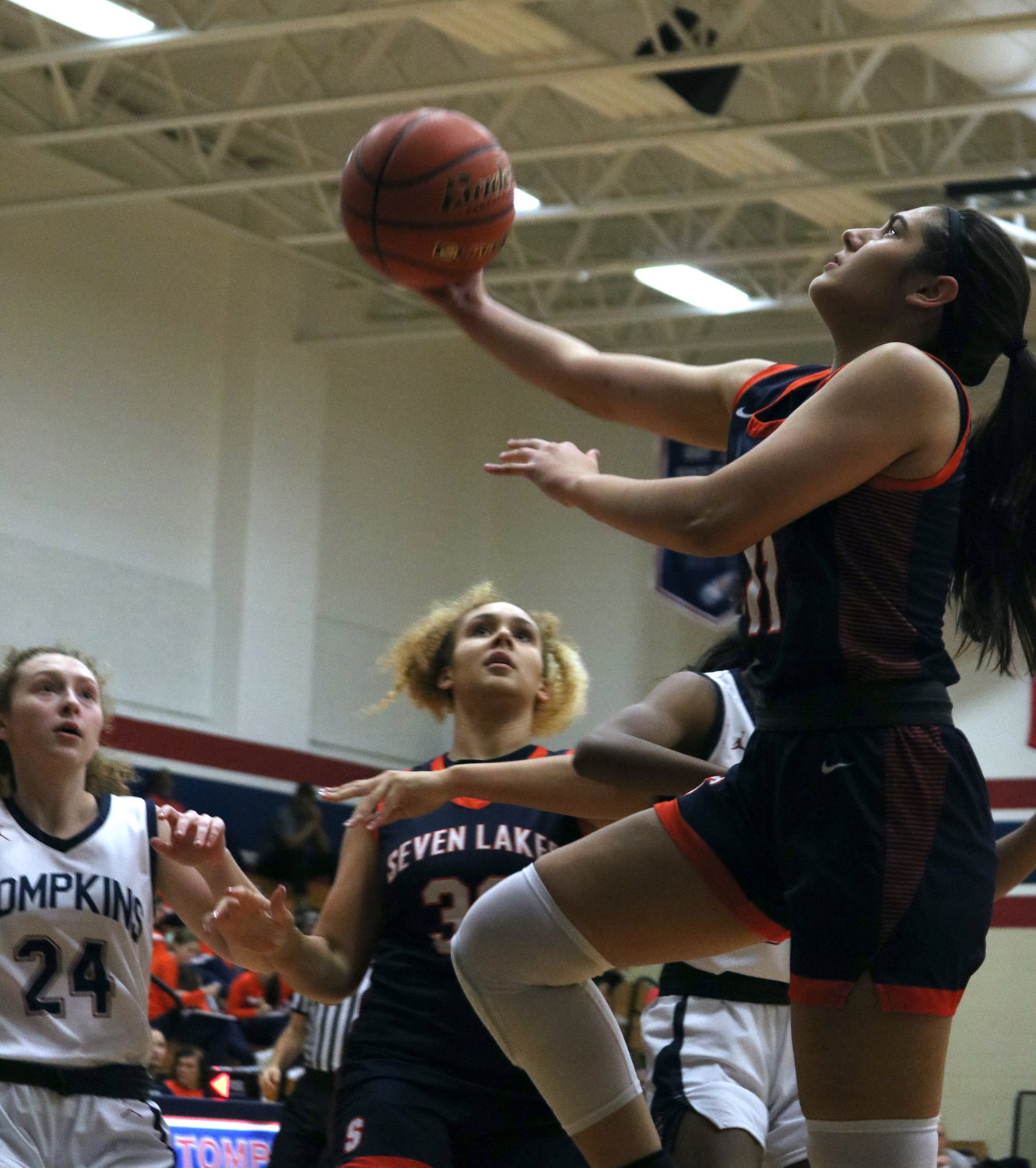 Macy Spencer shoots a floater during Tuesday’s District 19-6A game between Tompkins and Seven Lakes at the Tompkins gym.