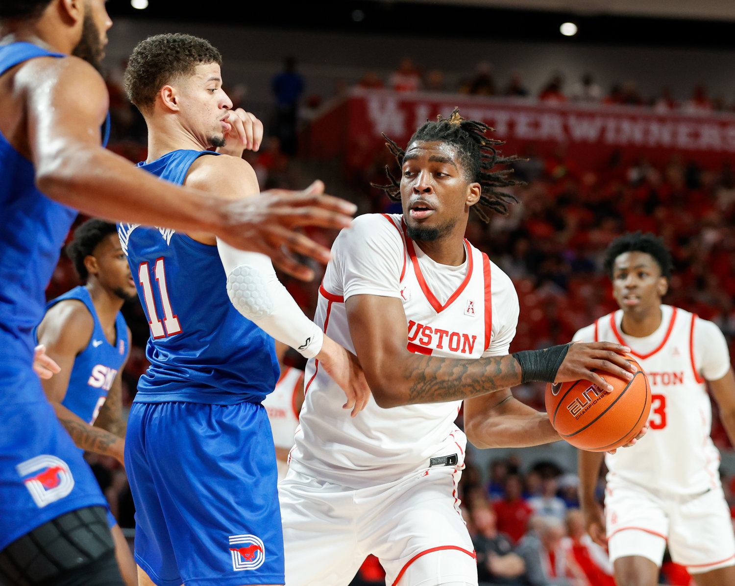 Houston forward Ja'Vier Francis (5) looks to pass during an NCAA men’s basketball game between the Houston Cougars and the Southern Methodist Mustangs on Jan. 5, 2023 in Houston. Houston won, 87-53,