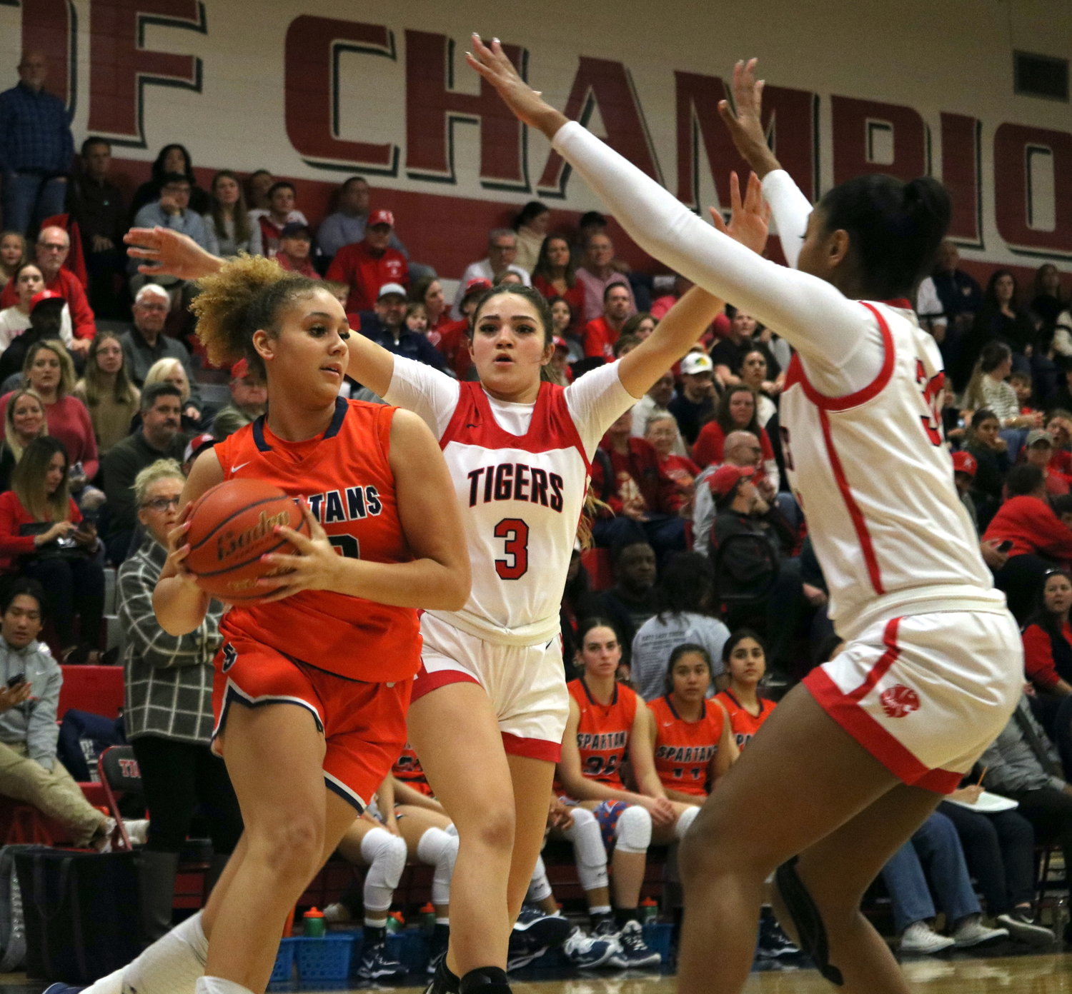 Justice Carlton drives between two defenders during Friday's game between Seven Lakes and Katy at the Katy gym.