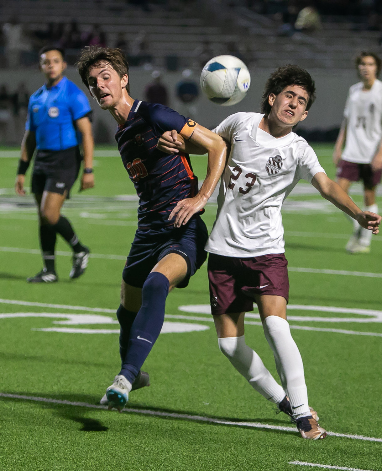 Aidan Morrison and Noah Bosso fight to bring down a ball during Friday's Class 6A Regional Quarterfinal game between Seven Lakes and Cinco Ranch at Legacy Stadium.
