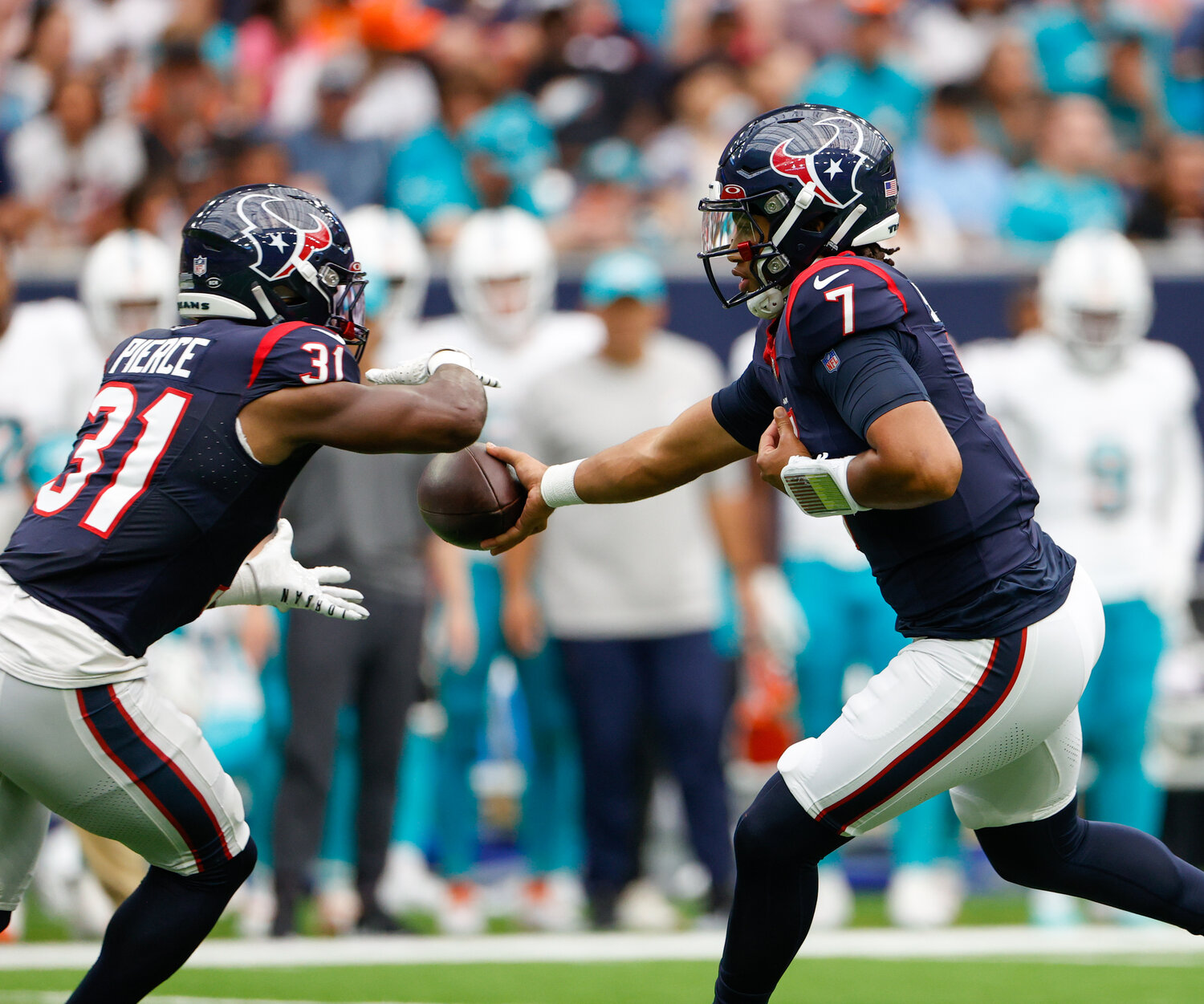 Houston Texans quarterback C.J. Stroud (7) hands the ball off to running back Dameon Pierce (31) during an NFL preseason game between the Texans and the Dolphins Jaguars on August 19, 2023 in Houston.