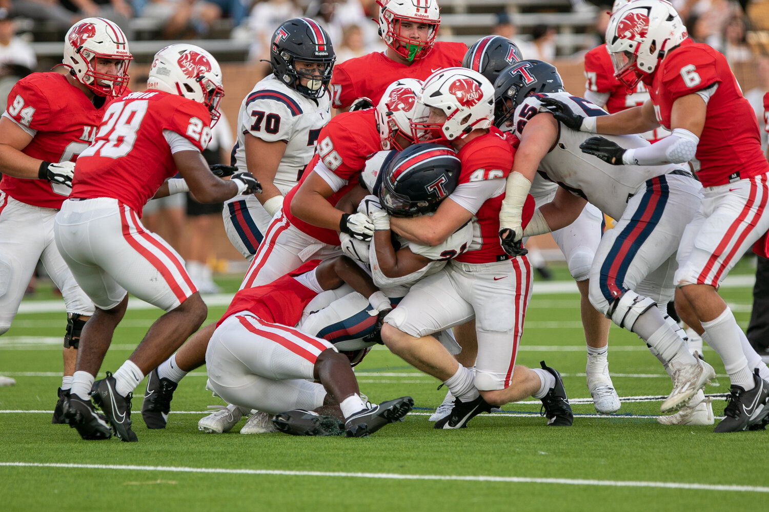 Caleb Blocker is wrapped up by the Katy defense during Friday's game between Katy and Tompkins at Rhodes Stadium.