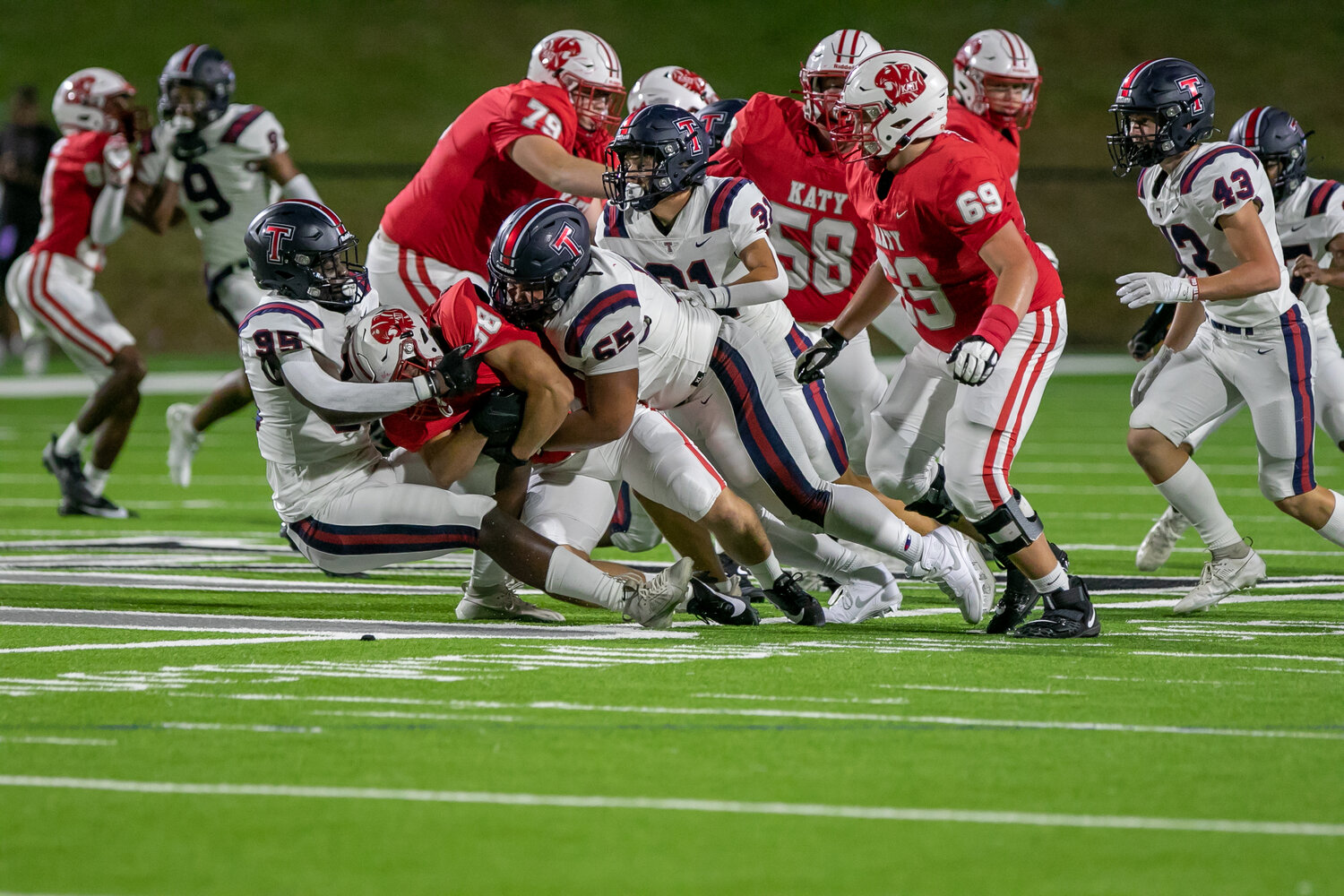 Tompkins defenders bring down a Katy player during Friday's game between Katy and Tompkins at Rhodes Stadium.