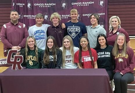 Cinco Ranch student athletes pose for a photo on national signing day.